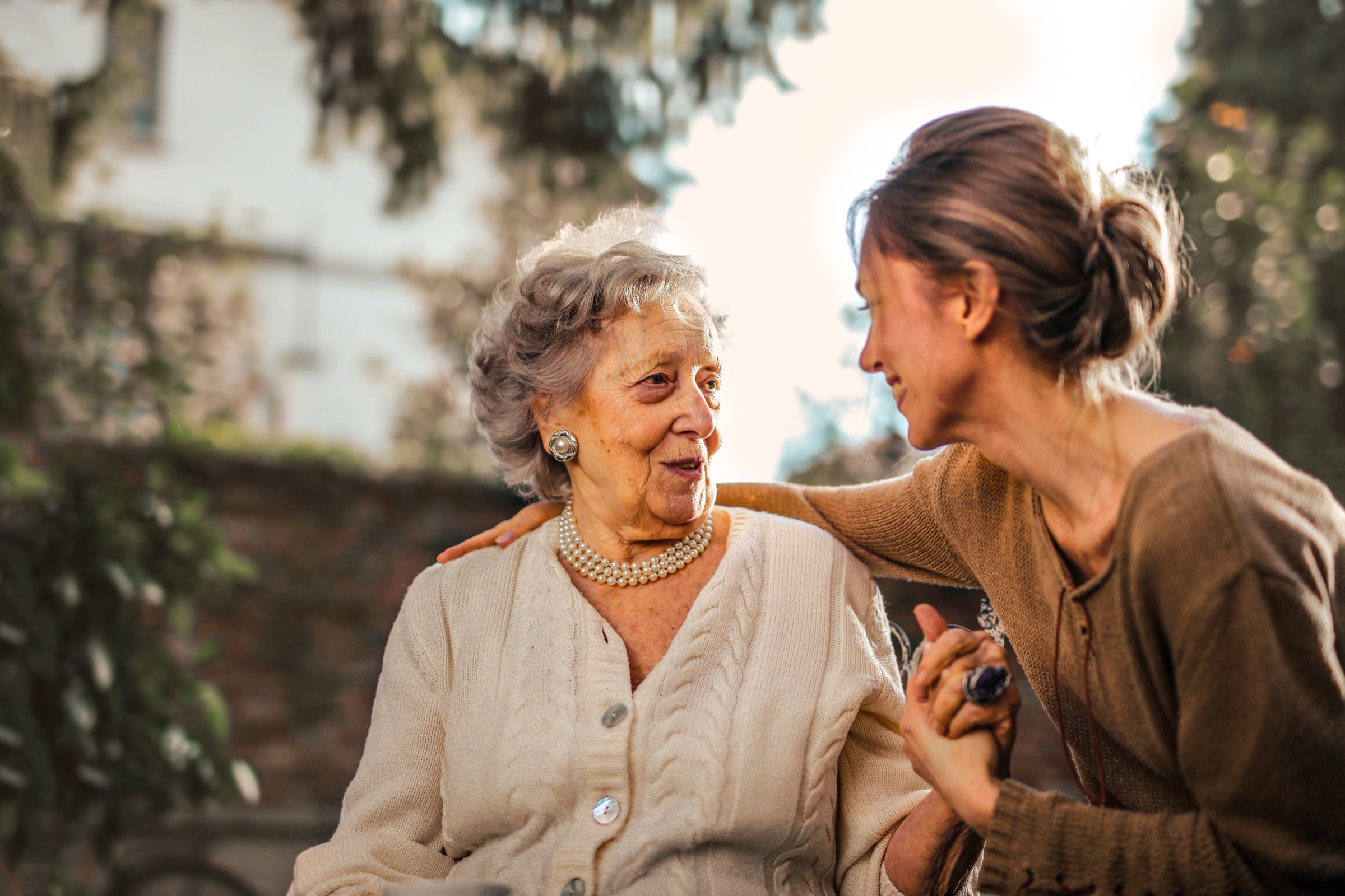 An older woman enjoying time outdoors with a companion.